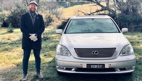 Voksy standing by silver Lexus