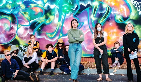 Young people standing in front of graffiti wall