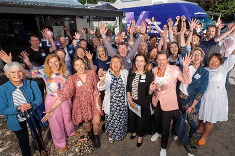 Group of Migrant Women In Business members waving at the camera 